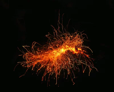 Dynamic Orange and Yellow Light Streaks on Black Background Capturing Energy image